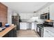 Well-lit kitchen with stainless steel appliances, white cabinets, and an island for extra counter space at 11827 Brook Rd, Golden, CO 80403