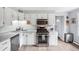 Functional kitchen featuring white cabinetry, stainless steel appliances, and laminate countertops at 11827 Brook Rd, Golden, CO 80403