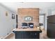 Kitchen island with stone and brick features, offering plenty of space and charm at 11827 Brook Rd, Golden, CO 80403