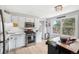 Bright and functional kitchen with stainless steel appliances, white cabinets, and a view of the outdoors at 11827 Brook Rd, Golden, CO 80403