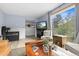 Stylish living room featuring a large window offering scenic views, wood floors, comfortable seating, and a wooden coffee table at 11827 Brook Rd, Golden, CO 80403