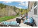 Outdoor brick patio area with comfortable seating and scenic wooded views at 11827 Brook Rd, Golden, CO 80403