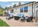 Outdoor brick patio with comfortable seating, a fire pit, and views of the surrounding area at 11827 Brook Rd, Golden, CO 80403