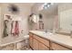 Bright bathroom with a single sink vanity, tile flooring, and shower with tub at 2951 W Riverwalk Cir # N, Littleton, CO 80123
