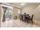 Light-filled dining room with tiled floors and a glass door leading to outdoor patio at 2951 W Riverwalk Cir # N, Littleton, CO 80123
