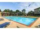 Outdoor swimming pool surrounded by chairs and greenery with colorful decorations at 2951 W Riverwalk Cir # N, Littleton, CO 80123