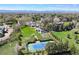 A sprawling property featuring a tennis court, gardens, and multiple buildings amidst lush greenery at 4682 S Franklin St, Englewood, CO 80113
