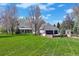Sprawling backyard with lush lawn, mature trees, and multi-car garage offers privacy and space at 4682 S Franklin St, Englewood, CO 80113