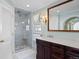 Bathroom features a marble walk-in shower with glass door, vanity with marble countertop, and soft blue walls at 4682 S Franklin St, Englewood, CO 80113