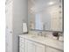 This bathroom features a single sink vanity with drawers, a large mirror, and decorative lighting fixtures at 4682 S Franklin St, Englewood, CO 80113