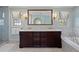 This bathroom features a dual sink vanity with marble countertop and a bathtub for a spa-like experience at 4682 S Franklin St, Englewood, CO 80113