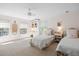 Bright and airy bedroom with two beds, a ceiling fan, desk and shelving for storage and display at 4682 S Franklin St, Englewood, CO 80113