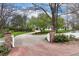 Long gravel driveway leading to a charming home with mature trees and landscaping at 4682 S Franklin St, Englewood, CO 80113