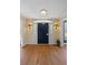 Welcoming entryway featuring a dark front door with sidelights and gleaming hardwood floors at 4682 S Franklin St, Englewood, CO 80113
