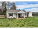 Quaint home with a charming front porch, brick accents, and well-manicured lawn providing curb appeal at 4682 S Franklin St, Englewood, CO 80113