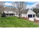 Well-maintained home with a lush lawn, charming covered patio, and attached garage, perfect for Gathering living at 4682 S Franklin St, Englewood, CO 80113