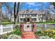Charming two-story home with a white picket fence, brick pathway, and manicured landscaping at 4682 S Franklin St, Englewood, CO 80113