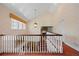 Bright hallway with white railings, patterned walls, and a view of a well-lit office space at 4682 S Franklin St, Englewood, CO 80113