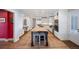 Spacious kitchen with white cabinets, stainless steel appliances, and a large island with seating at 4682 S Franklin St, Englewood, CO 80113