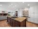 Open kitchen featuring a large center island with a cooktop and custom cabinetry at 4682 S Franklin St, Englewood, CO 80113