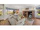 Cozy living room featuring a brick fireplace, bay window and comfortable furniture at 4682 S Franklin St, Englewood, CO 80113