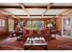 Cozy living room with wood-paneled walls, built-in bookshelves, and a coffered ceiling at 4682 S Franklin St, Englewood, CO 80113