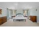 Bright main bedroom features neutral carpet and ceiling fan and soft blue walls for a relaxing retreat at 4682 S Franklin St, Englewood, CO 80113