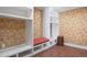 Well-organized mudroom with built-in storage, bench seating, and stylish patterned wallpaper at 4682 S Franklin St, Englewood, CO 80113