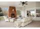 Cozy sunroom featuring a brick fireplace and white wicker furniture creating a relaxing atmosphere at 4682 S Franklin St, Englewood, CO 80113