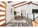 Well-lit dining area with modern decor, table, and wood-beamed ceiling at 12674 W 38Th Dr, Wheat Ridge, CO 80033