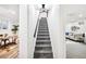 Carpeted staircase leading to a finished basement featuring a home office and a living room at 12674 W 38Th Dr, Wheat Ridge, CO 80033