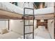 Unique bunk beds with a black pipe ladder and rustic wood accents at 645 S Park Ave # 302, Breckenridge, CO 80424