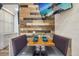 Cozy dining area with booth seating, complemented by a wood accent wall and a mounted flat screen TV at 645 S Park Ave # 302, Breckenridge, CO 80424