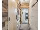 Hallway with tile flooring and decorative wood wall paneling leading into the kitchen at 645 S Park Ave # 302, Breckenridge, CO 80424