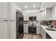 Modern kitchen with stainless steel appliances, white countertops, and wood-look flooring at 645 S Park Ave # 302, Breckenridge, CO 80424