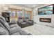 Modern living room with comfortable reclining seating, fireplace, and large flat-screen TV at 645 S Park Ave # 302, Breckenridge, CO 80424
