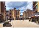Outdoor view of a quaint town square surrounded by multi-story buildings and shops under a partly cloudy sky at 645 S Park Ave # 302, Breckenridge, CO 80424