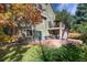 Expansive backyard with lush green lawn, patio, and mature trees, ideal for outdoor living at 6296 W Prentice Ave, Littleton, CO 80123