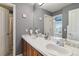 Bright bathroom with double sinks, a large mirror, and a shower-tub combination, offering convenience and style at 6296 W Prentice Ave, Littleton, CO 80123