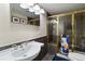 Bathroom featuring a luxurious, glass-enclosed shower with bronze hardware, and a pedestal sink at 6296 W Prentice Ave, Littleton, CO 80123