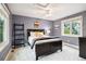 Cozy bedroom with a large window, a ceiling fan, and a comfortable queen-size bed, perfect for relaxation at 6296 W Prentice Ave, Littleton, CO 80123
