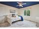 Comfortable bedroom featuring a blue ceiling, plush bedding, large windows, and a ceiling fan at 6296 W Prentice Ave, Littleton, CO 80123