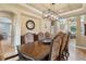 Formal dining room with hardwood floors, chandelier, and stairway in the background at 6296 W Prentice Ave, Littleton, CO 80123