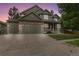 Charming two-story home with stone accents, lush landscaping, and a three car garage at 6296 W Prentice Ave, Littleton, CO 80123