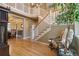 Spacious foyer with hardwood floors, a grand staircase, and decorative details at 6296 W Prentice Ave, Littleton, CO 80123