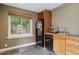 Cozy kitchen features stainless steel appliances, natural light, and custom wood cabinets at 6296 W Prentice Ave, Littleton, CO 80123