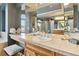Elegant main bathroom featuring a vanity with double sinks and ample mirror space at 6296 W Prentice Ave, Littleton, CO 80123