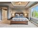 This is a well-lit primary bedroom with a large bed, ceiling fan, and an arched doorway at 6296 W Prentice Ave, Littleton, CO 80123