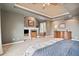 Comfortable main bedroom has a fireplace, sitting area, and large dresser at 6296 W Prentice Ave, Littleton, CO 80123