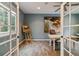 Bright office space featuring french doors, neutral paint, and wood-look floors at 6296 W Prentice Ave, Littleton, CO 80123